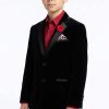 a boy wearing a velvet blazer with a pike lapel in black satin
