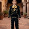 Boy wearing a black and gold charro mariachi suit with gold embroidered horseshoes and horse heads, gold metal buttons, matching sombrero, vest, white shirt, and bow tie.