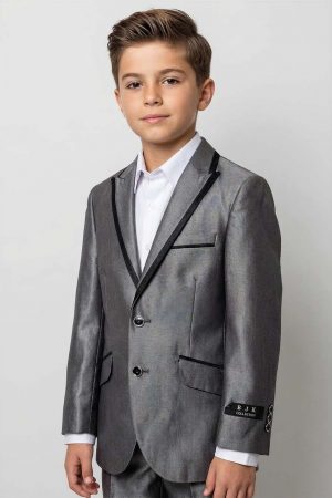 a boy wearing a shiny grey suit with matching pants and a white shirt.