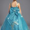 A shiny glittered dress for girls in a Turquoise color with gold glitter and sequins. The back has a large removable bow with the same fabric as the dress