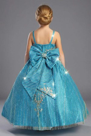 A shiny glittered dress for girls in a Turquoise color with gold glitter and sequins. The back has a large removable bow with the same fabric as the dress