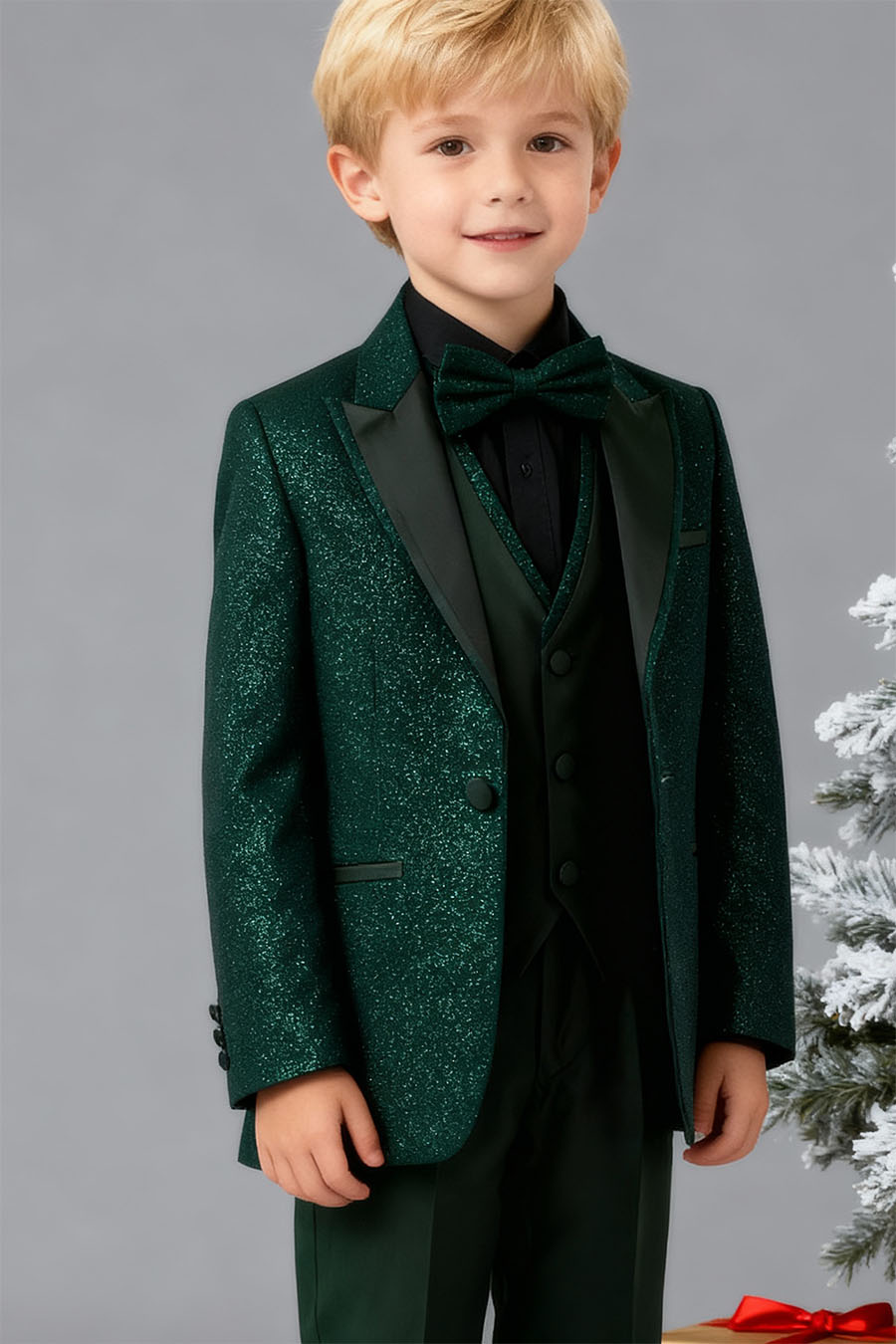 a boy's emerald green glitter suit with a pike lapel, matching vest and green pants Combined with a black shirt and a matching bowtie.