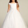 An all white tea length dress for girls. Simple yet elegant and with a slight glitter shine. Drop down shoulders and embroidered bodice, with slight glitter shine in the bottom skirt.