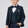 A boy wearing a teal and navy blue brocade suit