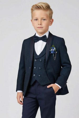 A boy wearing a teal and navy blue brocade suit