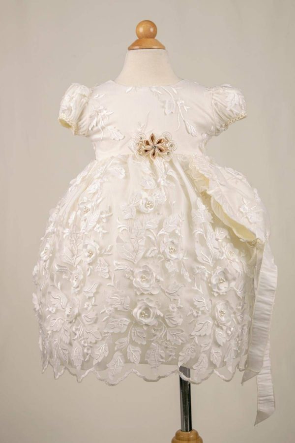 girl's short ivory baptism gown with a 3d fabric that has flowers and leaves as design.