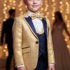 Boys gold jacquard tuxedo with navy blue satin lapel, matching vest, trousers, white dress shirt, and gold bow tie.