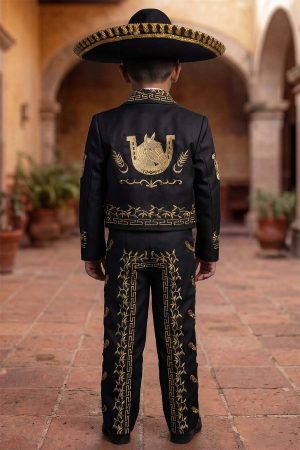 Boy wearing a black and gold charro mariachi suit with gold embroidered horseshoes and horse heads, gold metal buttons, matching sombrero, vest, white shirt, and bow tie.
